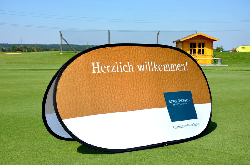 Breites Pop-Up Banner horizontal, aufgestellt auf einer Grünfläche, perfekt für Golfturniere.